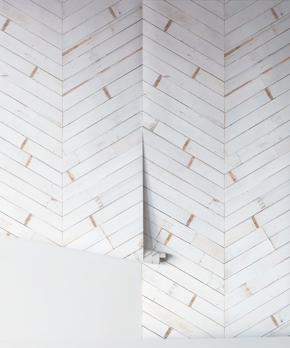 Distressed timber chevron is a white timber chevron wallpaper