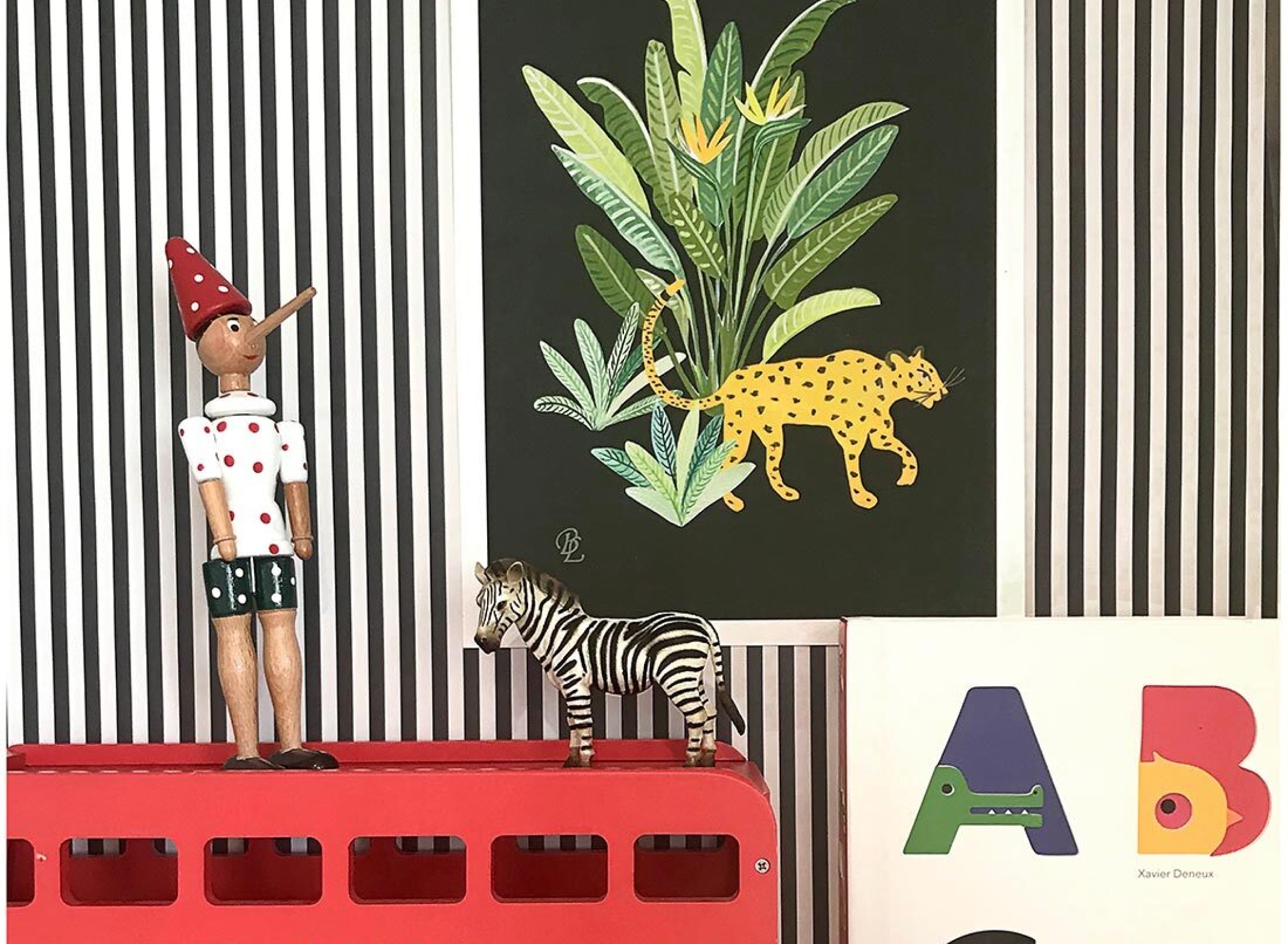 Candy stripe in charcoal in a child's bedroom with toys and framed art.