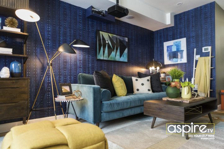 Dark Blue City Scape wallpaper from Milton & King on the wall with a teal sofa and brown coffee table