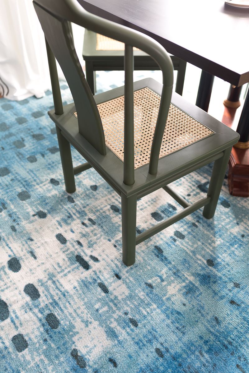 Jewel Marlowe Basement Makeover • Looking down on a green chair with sitting on a blue carpet