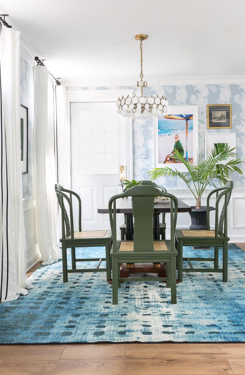 Jewel Marlowe Basement Makeover • A blue carpet with a kitchen table with green chairs and light blue magpie wallpaper from Milton & King on the wall