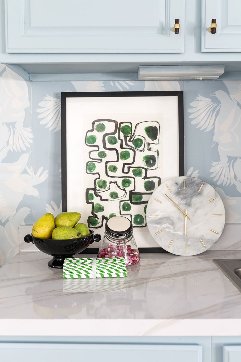 Jewel Marlow Basement Makeover • A kitchen counter top with a black bowl of green pears