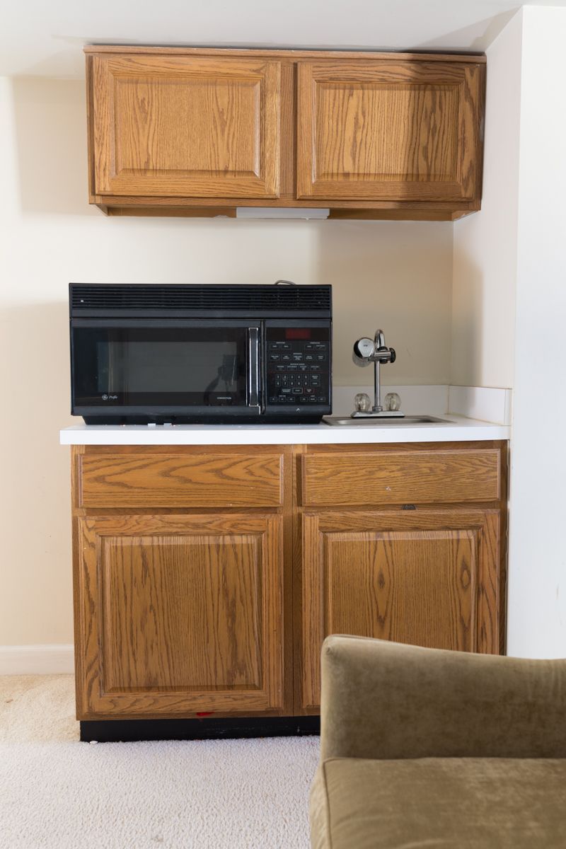 Jewel Marlowe Basement Makeover • a sink area with a microwave on top of the counter