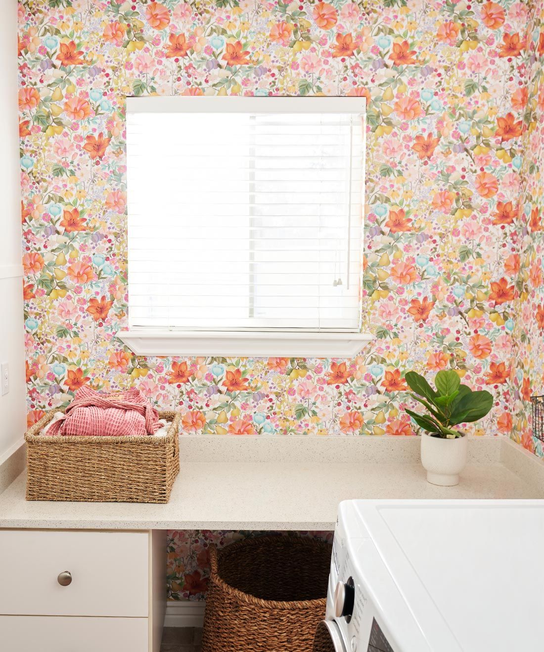 Abundance Wallpaper • Kip&Co • Colorful Floral Wallpaper • laundry room insitu with young girl sitting on washing machine by Morgan Pederson