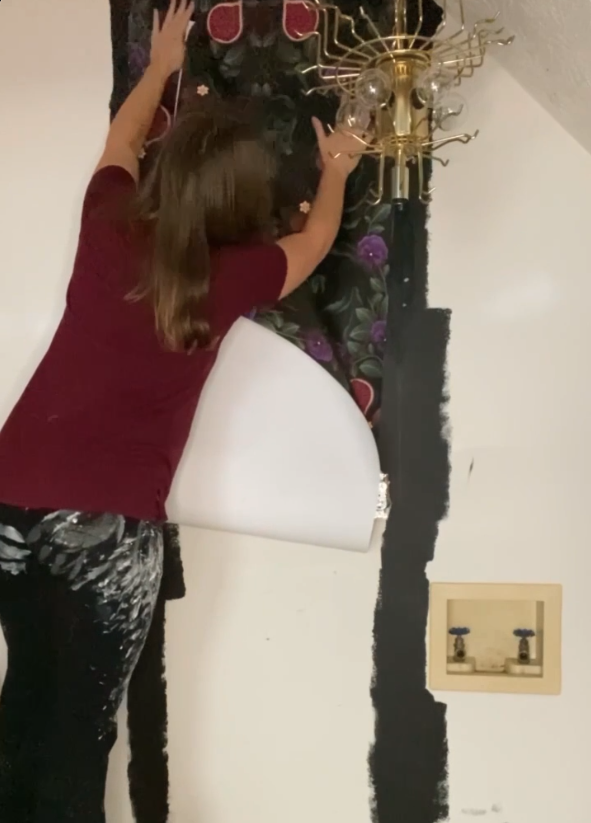 Lauren Dalstrup Installing the Figs & Strawberries Wallpaper using a banding technique on the wall to avoid the appearance of seam in her wallpaper installation