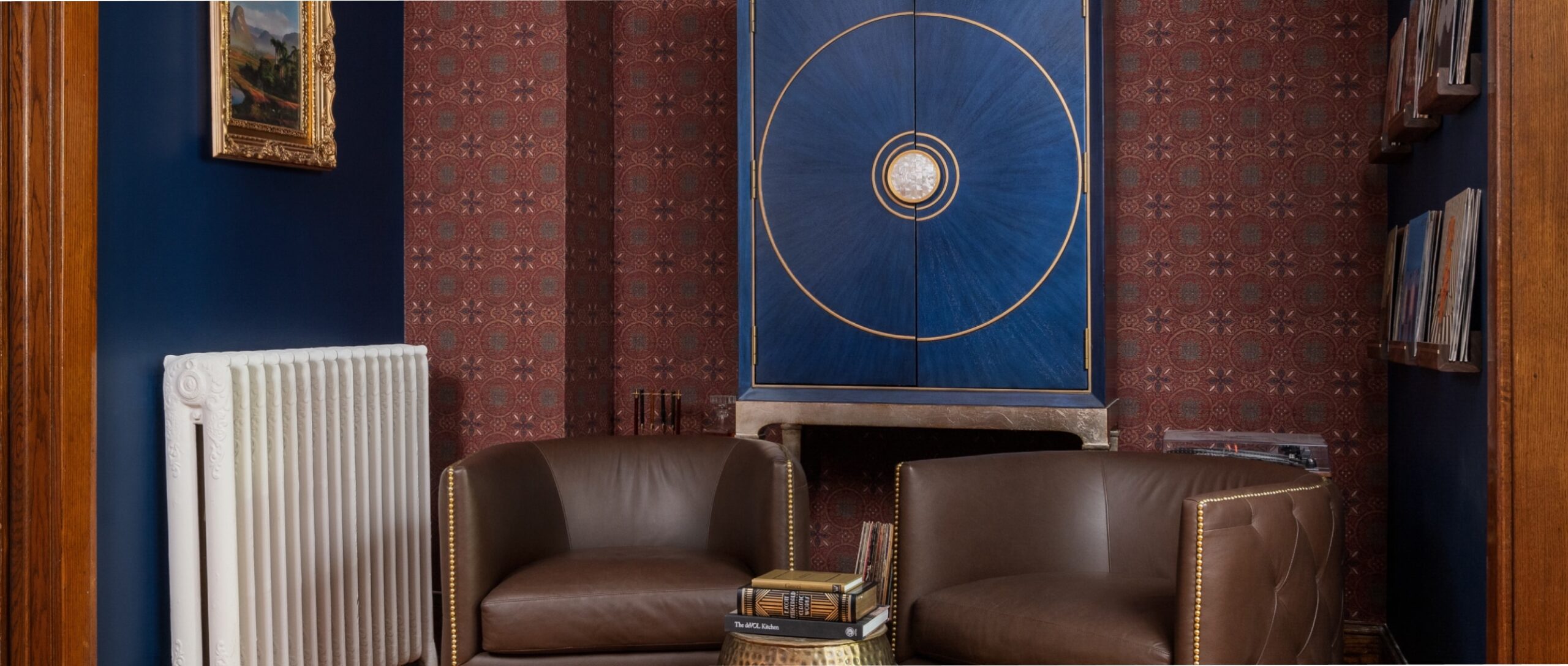 a room full of rich colors with deep burgundy wallpaper