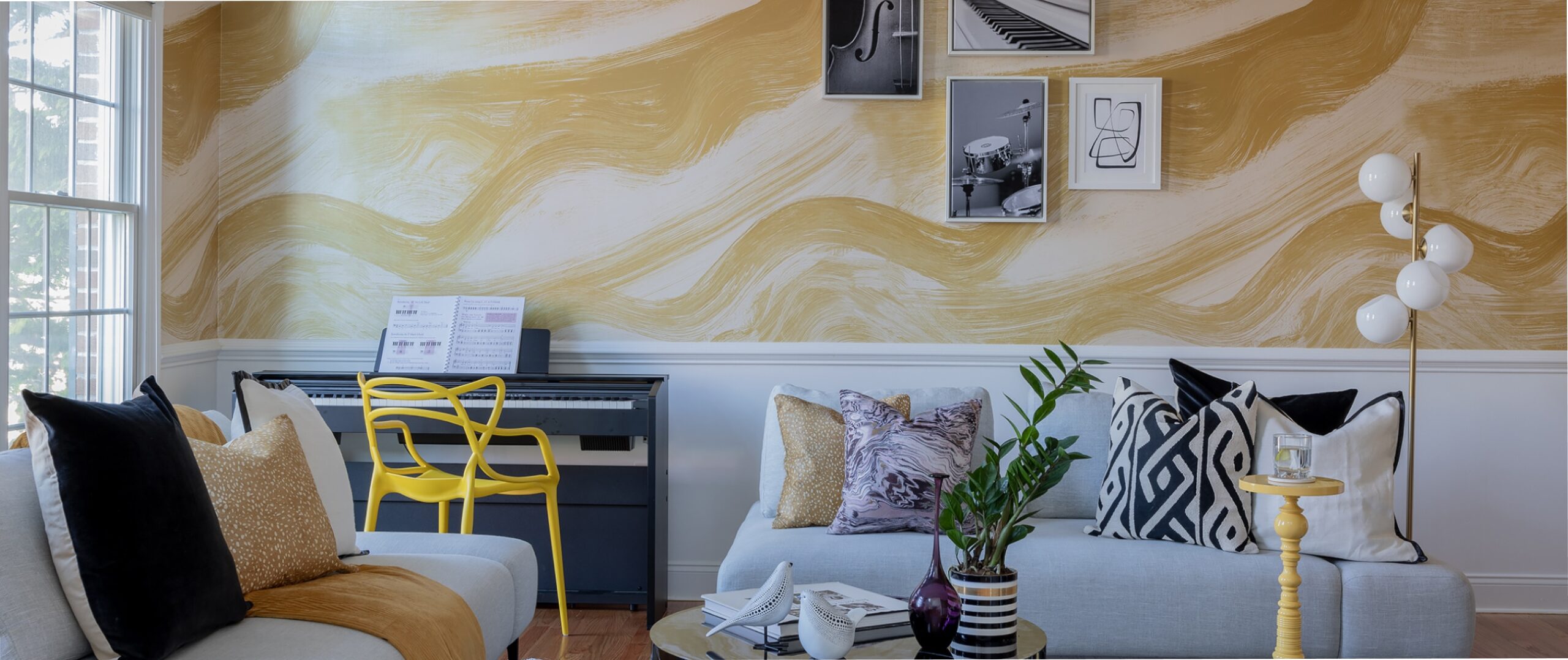Living room with warm yellow wallpaper by Daastann Inc