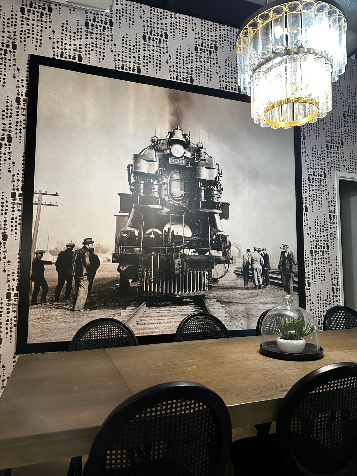 Black & White Rock line train Mural by a dining table.