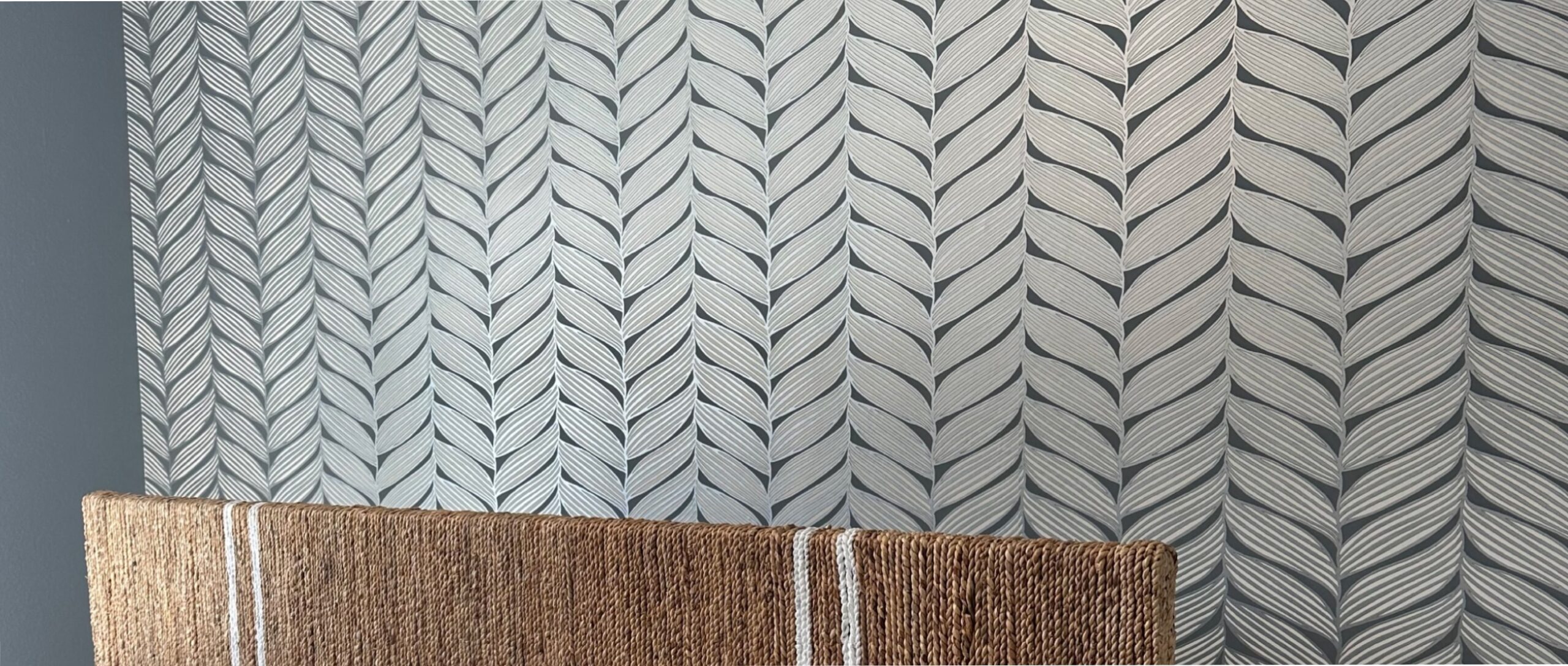 a wallpapered bedroom with blue walls