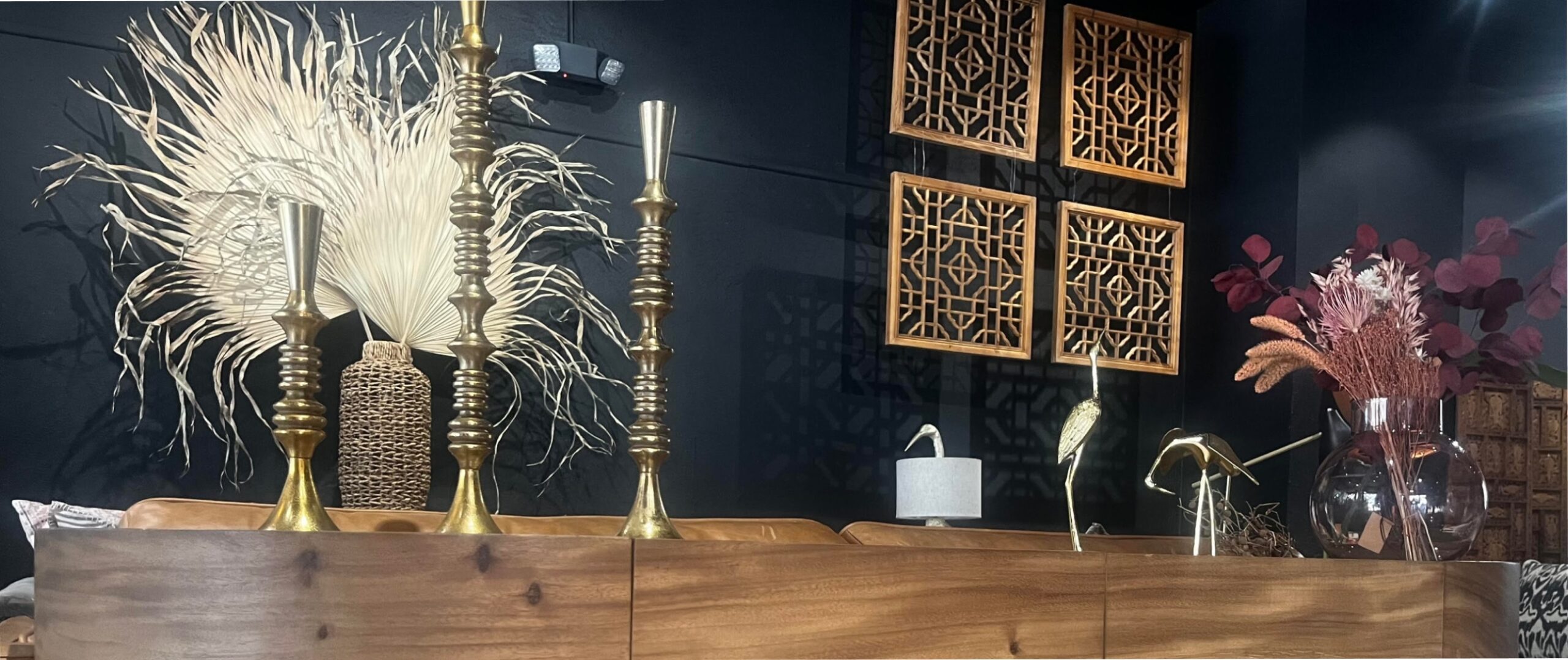 a black living room wall and Balinese decor