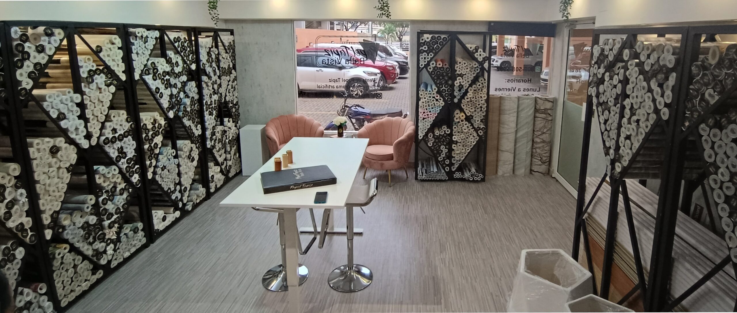 the inside of a wallpaper store with rolls of wallpaper for sale