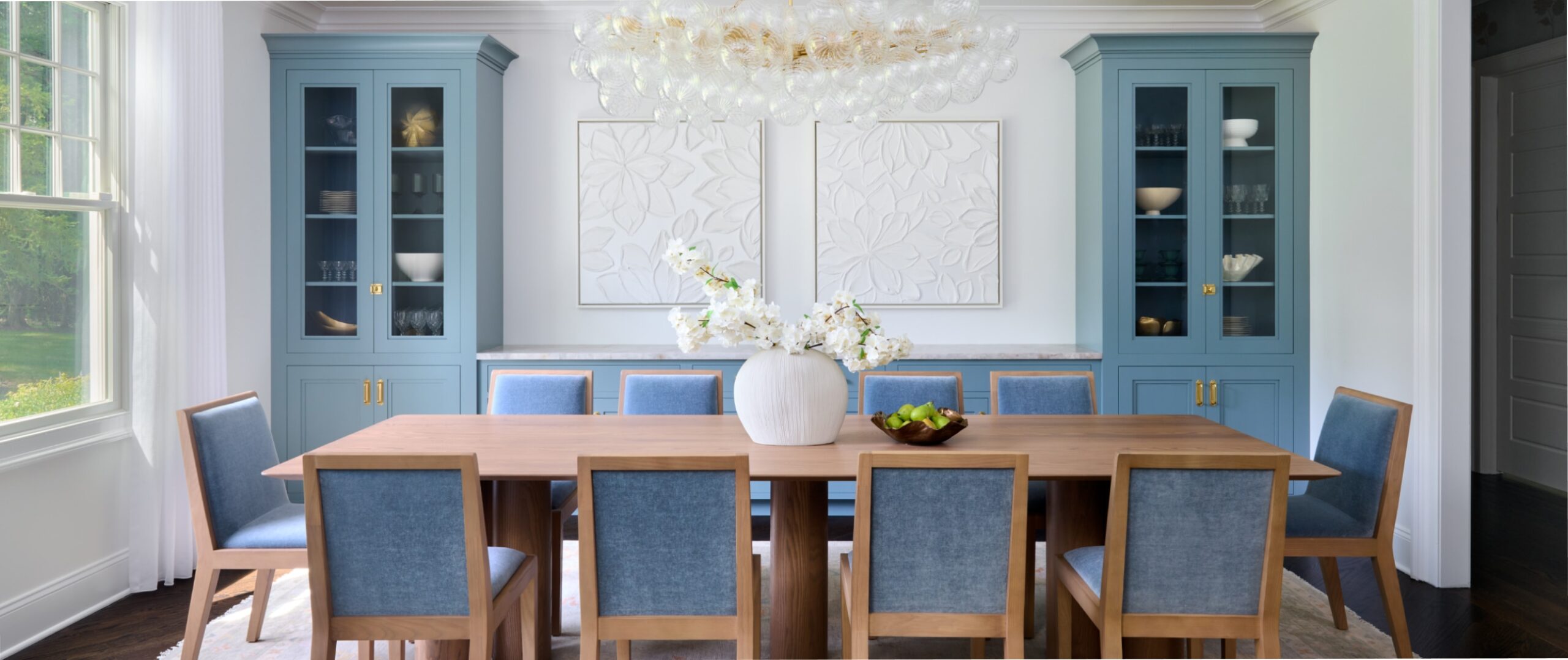 a modern dining room with blue built-ins