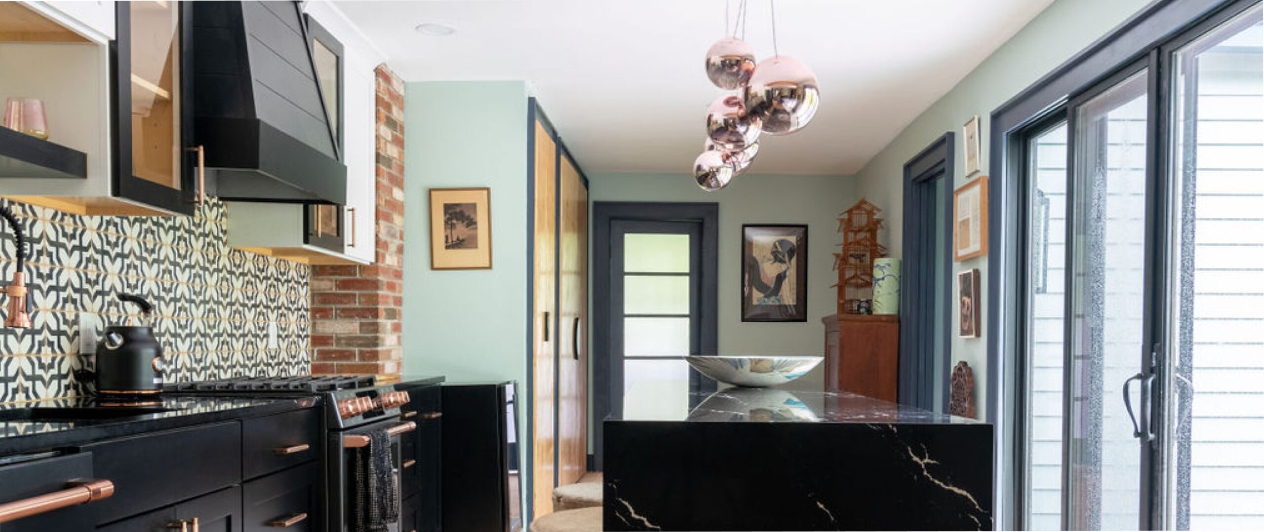 a modern kitchen with a black marble island by STORYLIKELY