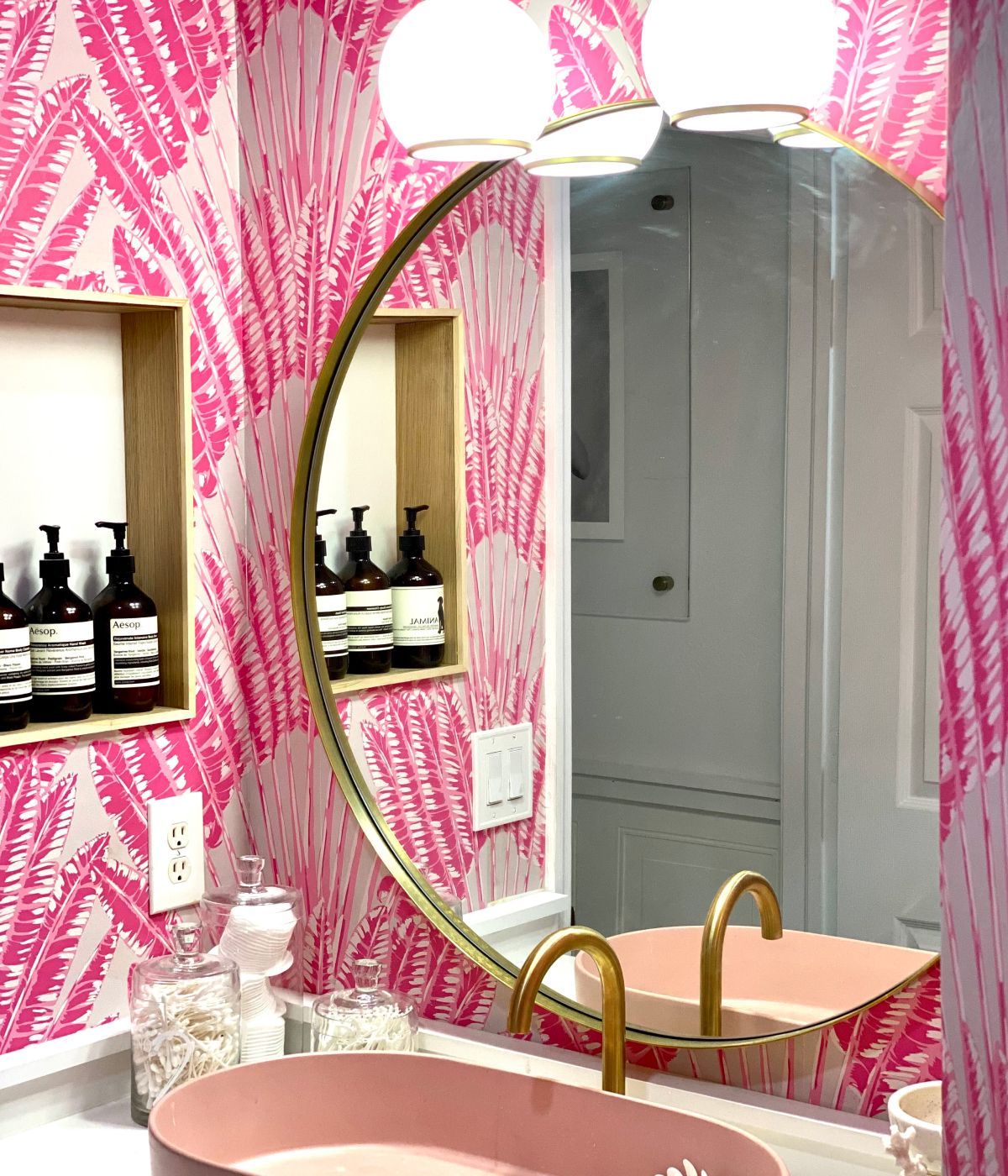 Magenta feather palm design in bathroom with gold and blush pink accents.