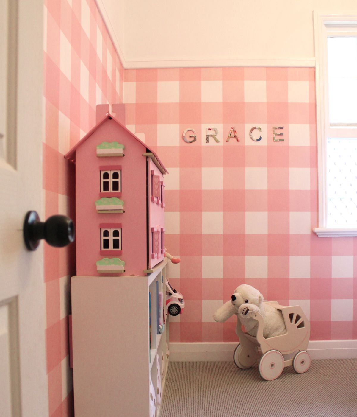 Pink check pattern wallpaper in child's play room.