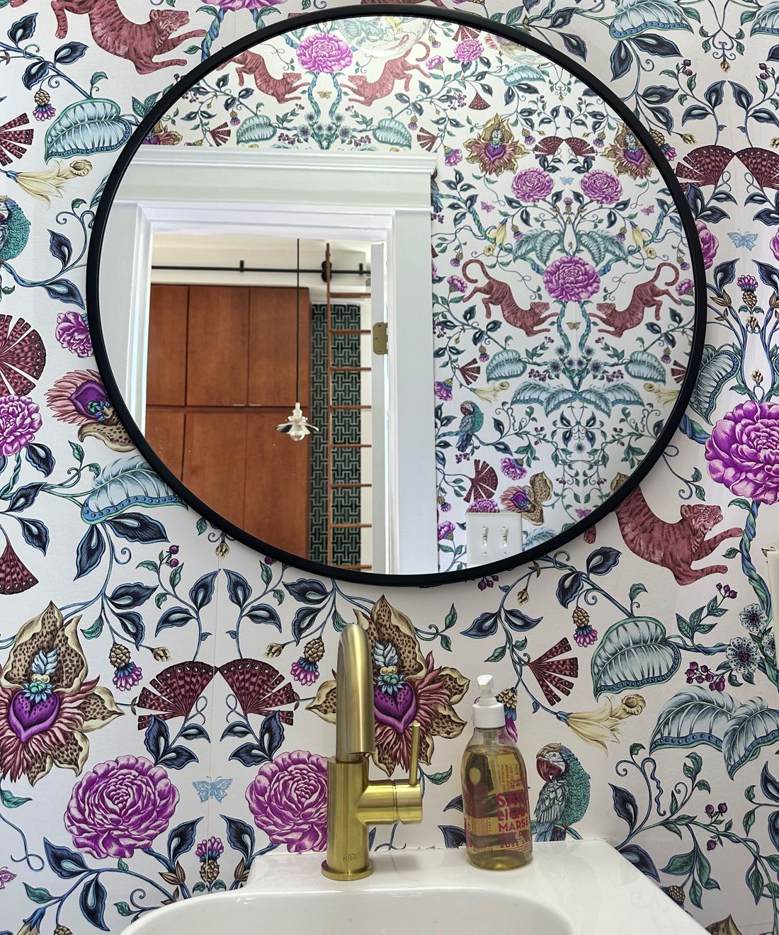 Playful Tiger Wallpaper • White • Powder Room Installation by Mallory Brame with circular black framed mirror