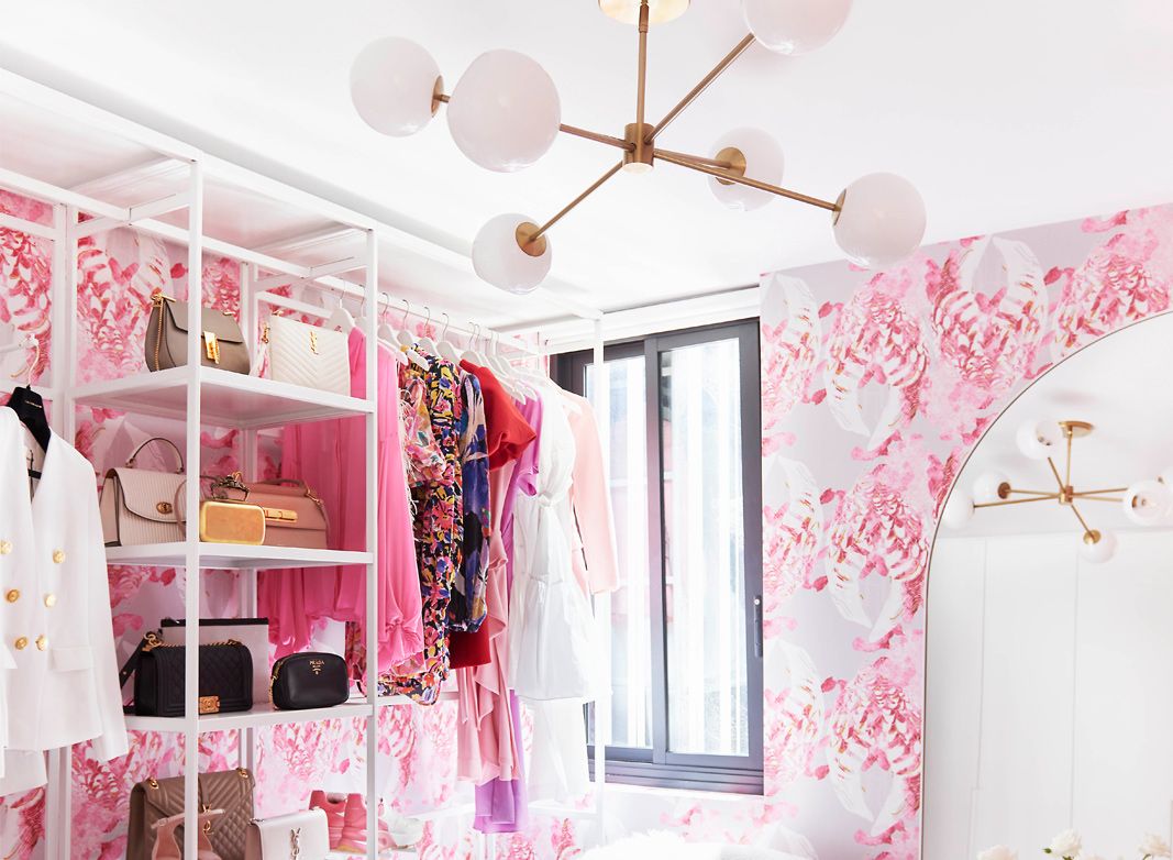 Kandos Wallpaper in a closet with a rack of shoes on the left wall and a contemporary pendant lamp