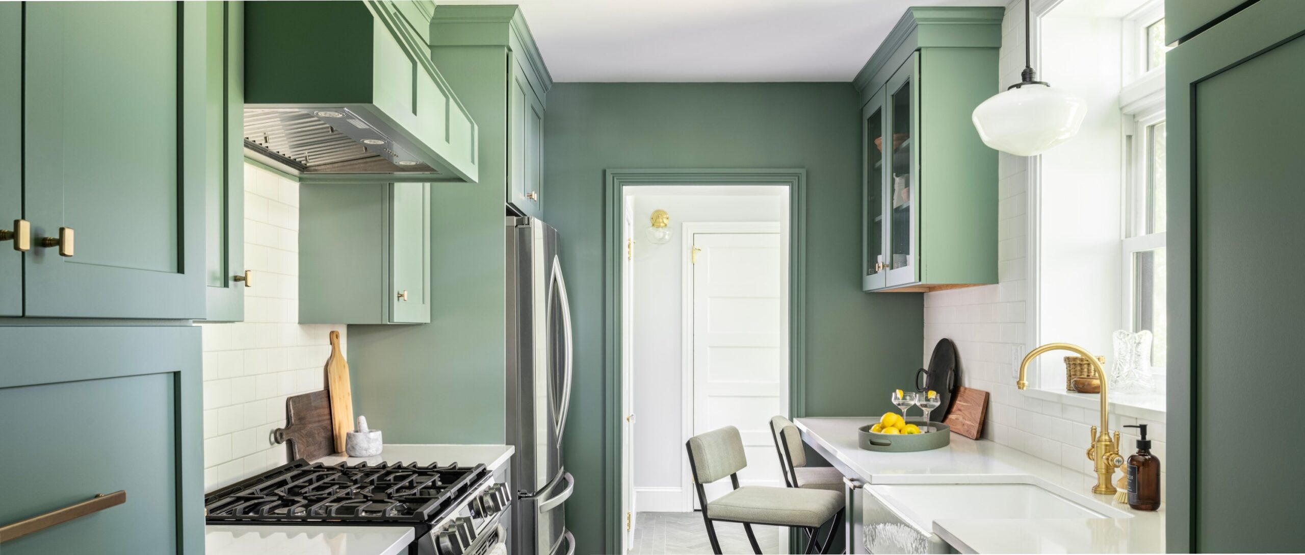 Rooted By Design's lovely green classic and modern galley kitchen