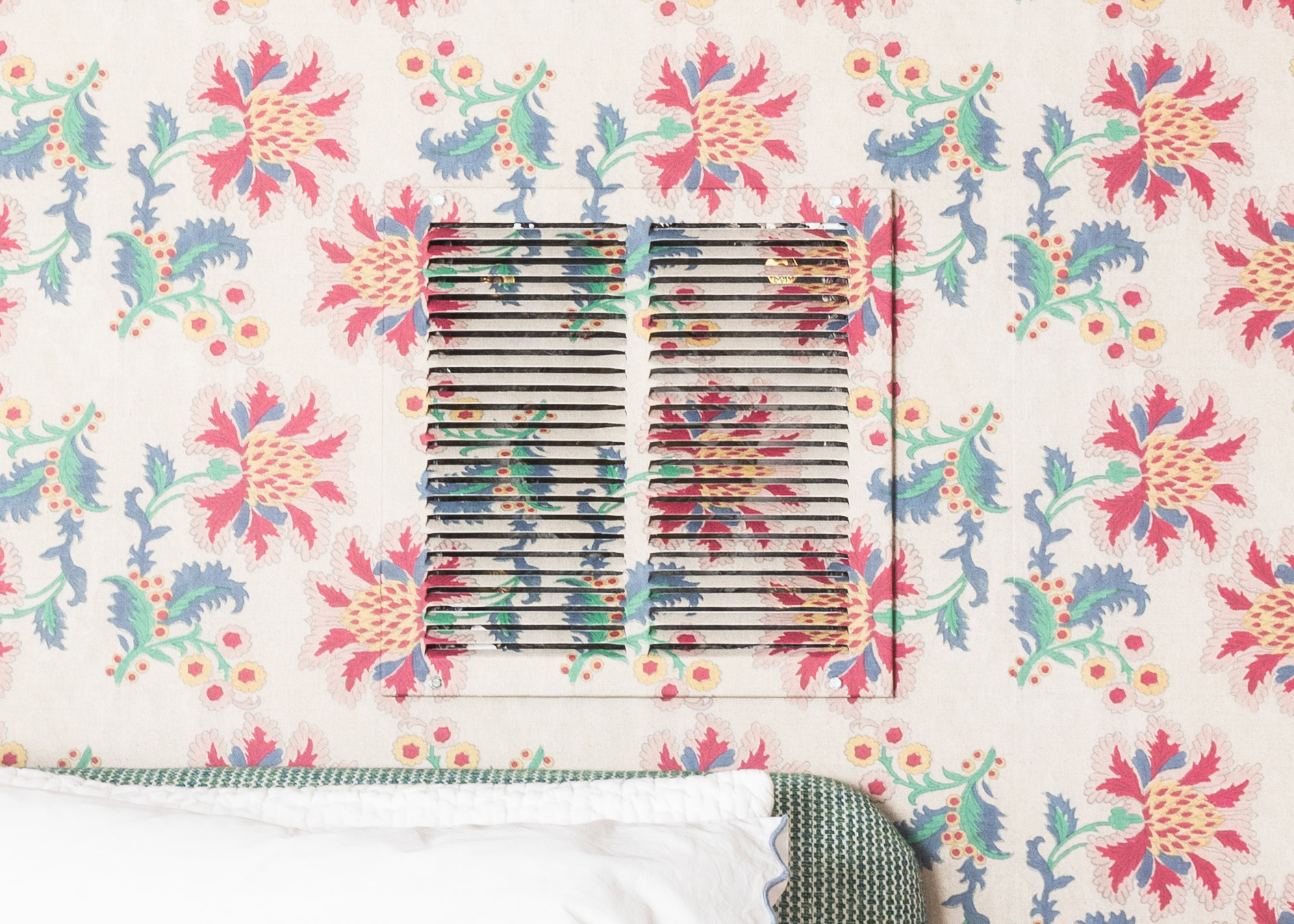 French Floral Wallpaper is on the wall and also installed over the metal air vent.