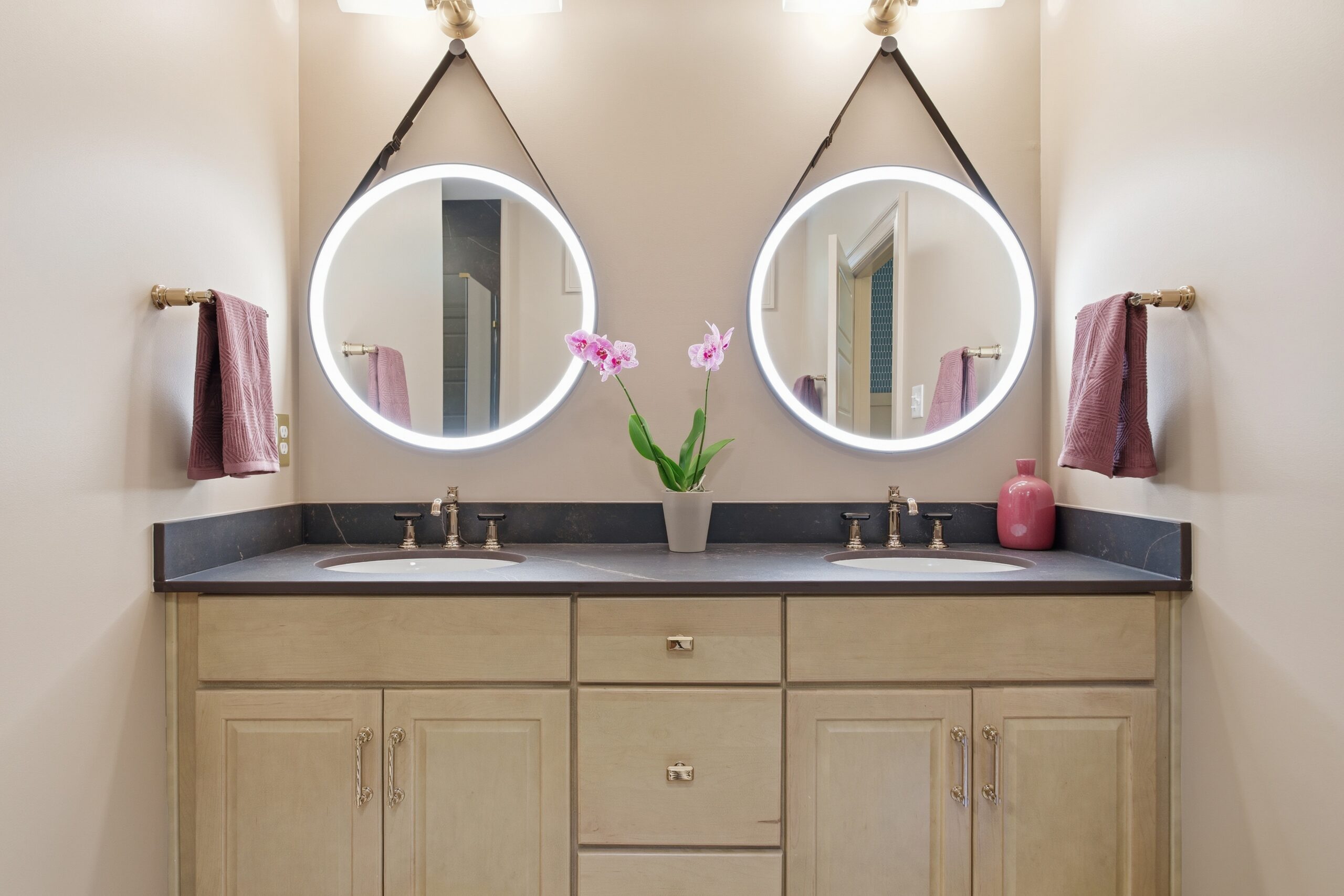 Bathroom sink with two circular mirrors
