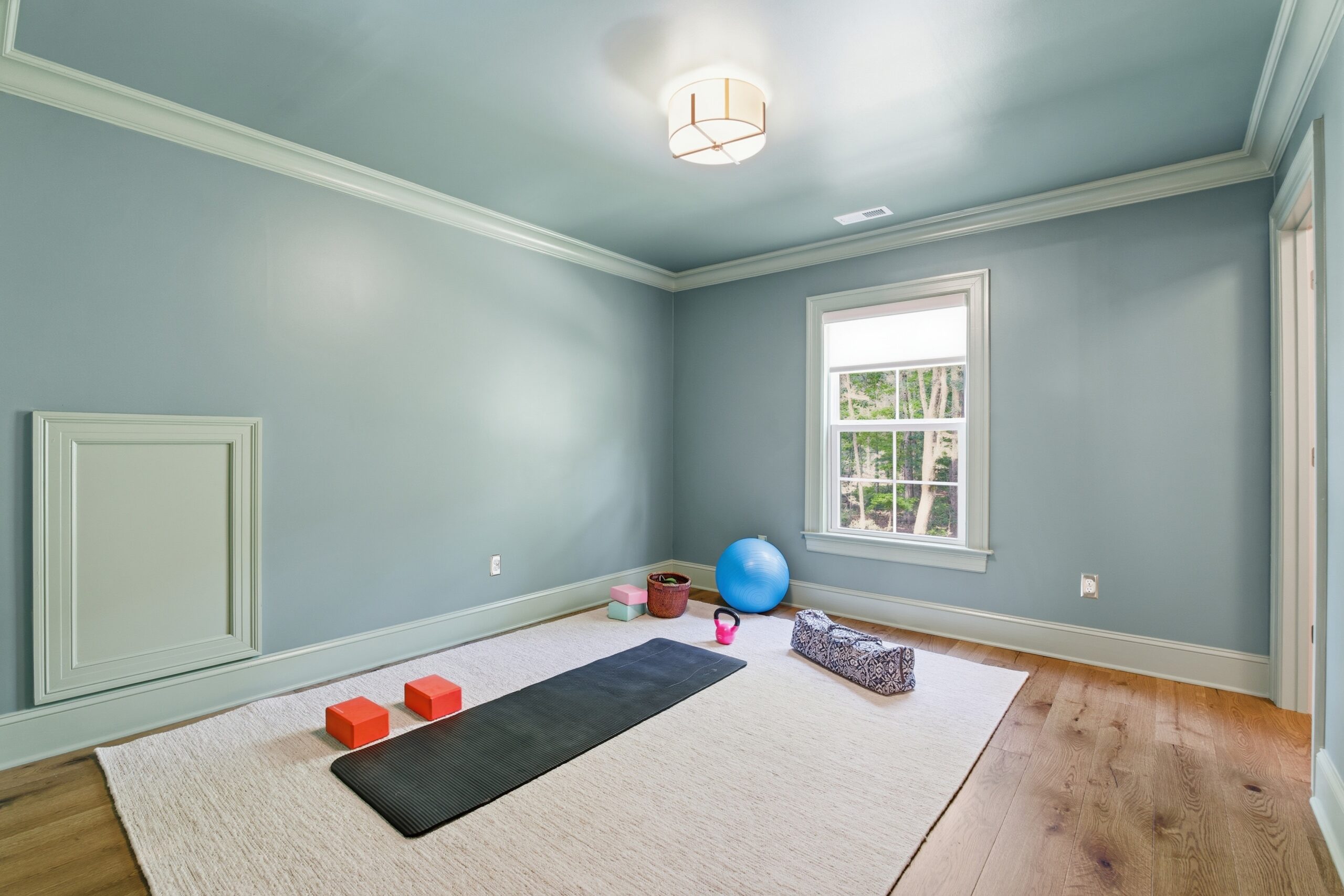 Workout room with a yoga mat on the floor